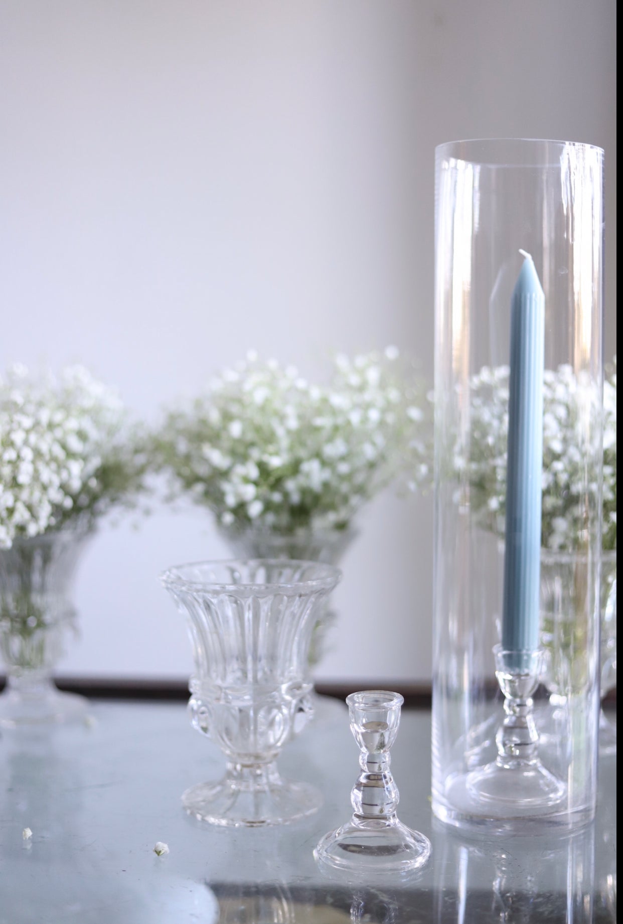 Taper candles in cylinder vase