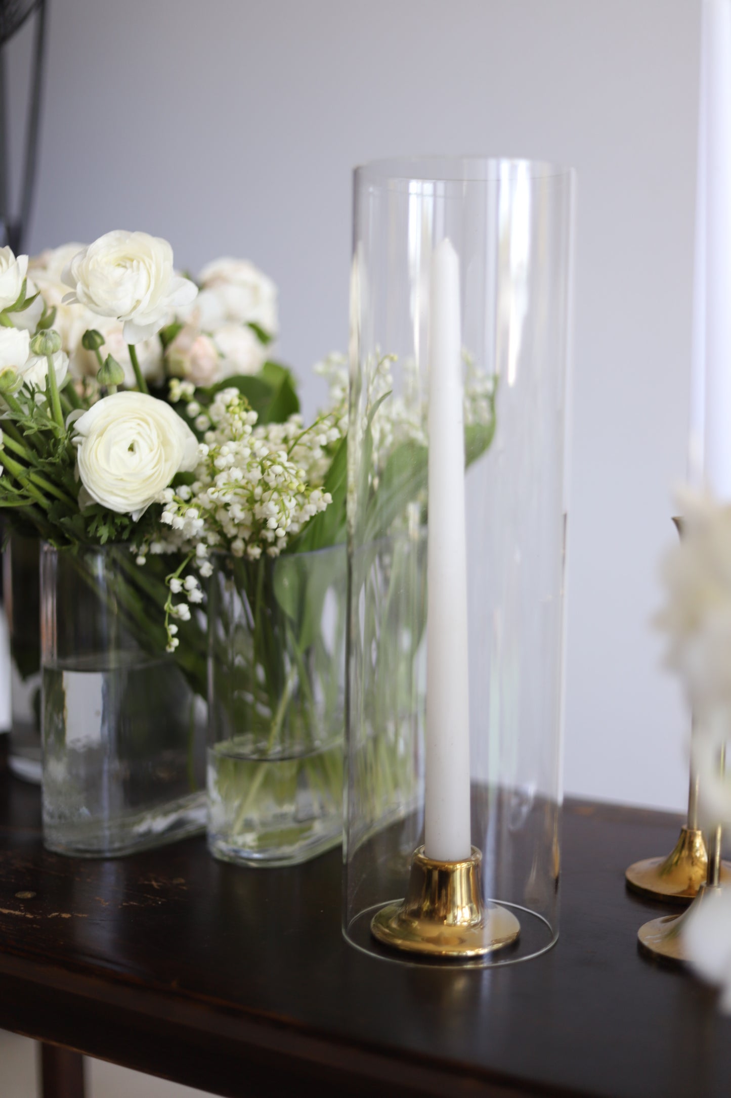 Taper candles in cylinder vase