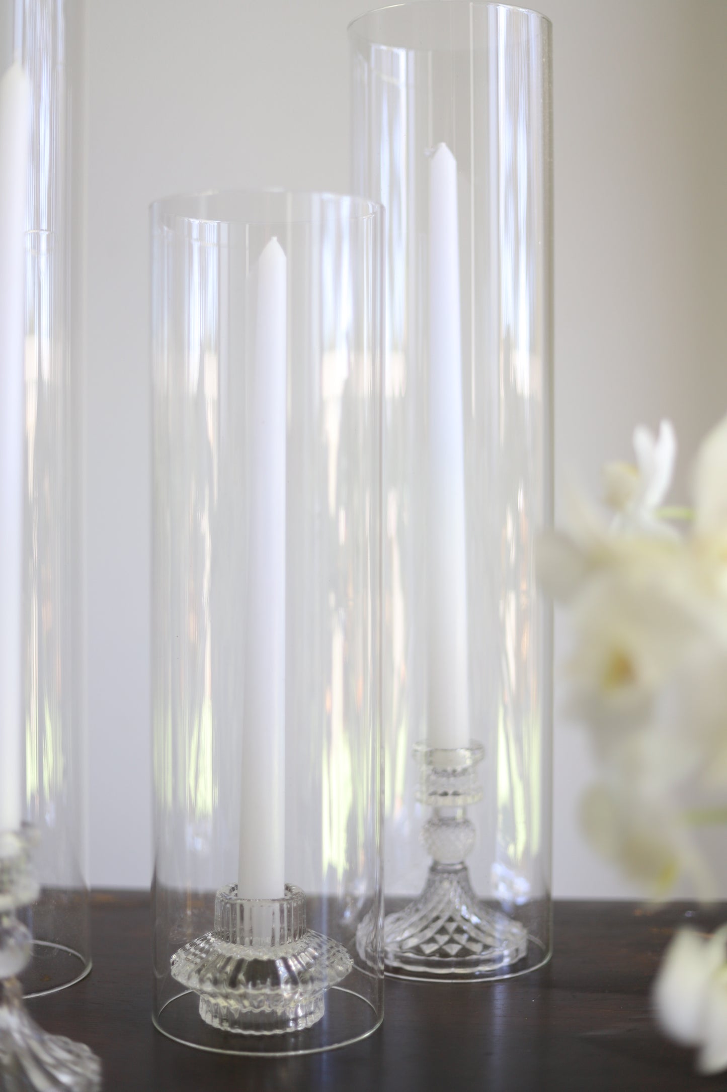 Taper candles in cylinder vase